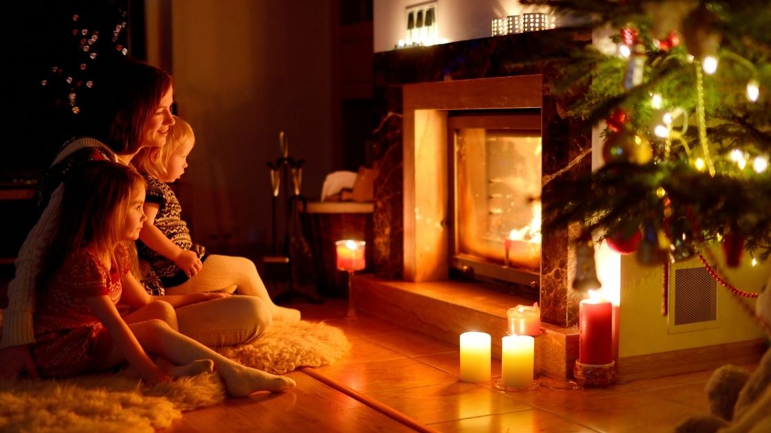 Family Sitting in front of fireplace