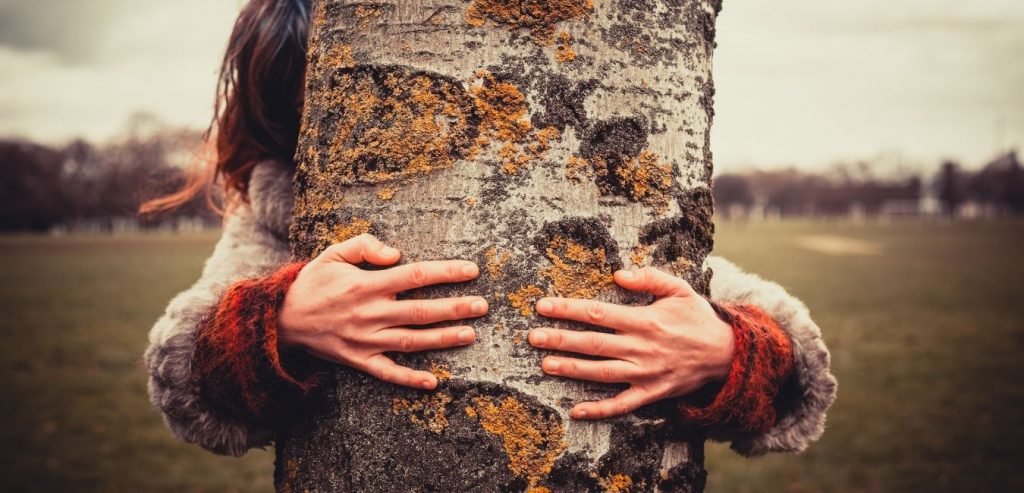 Woman hugging a tree